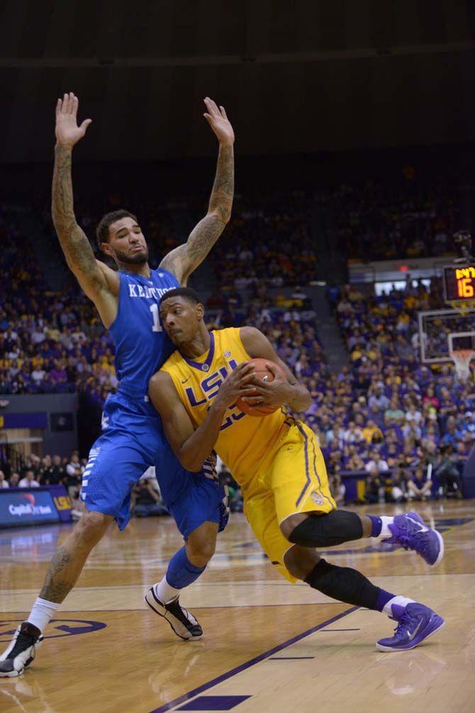 LSU sophomore forward Jordan Mickey (25) attempts a layup over Kentucky junior forward Willie Cauley-Stein (15) during the Tigers' 71-69 defeat on Tuesday, Feb. 10, 2015 in the Pete Maravich Assembly Center.