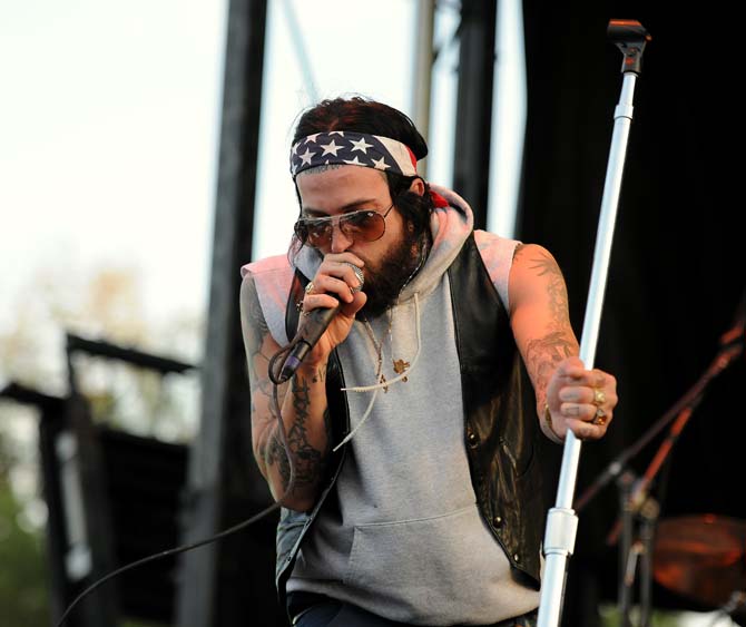 Michael Wayne Atha, known by his stage name Yelawolf, raps while holding the mic stand April 14, 2013 during Groovin' on the Grounds at the LSU Parade Grounds.