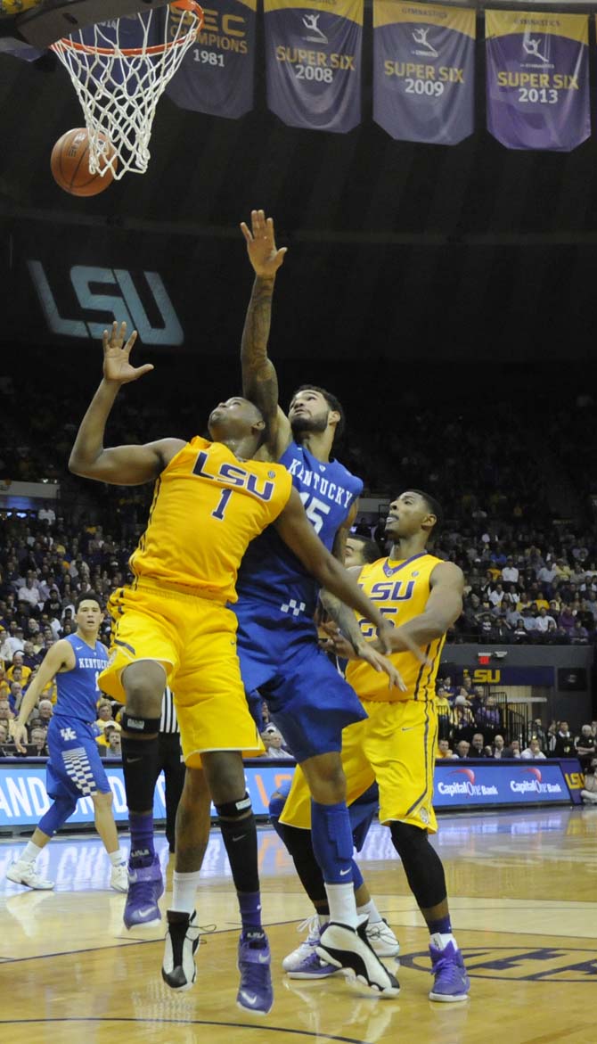 LSU sophomore forward Jarell Martin (1) and Kentucky junior forward Willie Cauley-Stein (15) attempt to grab a rebound during the Tigers' 71-69 loss against Kentucky on Tuesday, Feb. 10, 2015 in the Pete Maravich Assembly Center.