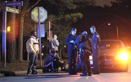 In this Tuesday, Feb. 10, 2015 photo, Chapel Hill police officers investigate the scene of three murders near Summerwalk Circle in Chapel Hill, N.C. A man, his wife and her sister, all college students, were shot to death at a quiet condominium complex near the University of North Carolina, but police had not yet given a motive or released details about the suspect. Craig Stephen Hicks, 46, was charged with three counts of first-degree murder in the Tuesday shooting, Chapel Hill police told local news outlets. (AP Photo/The News &amp; Observer, Al Drago) MANDATORY CREDIT