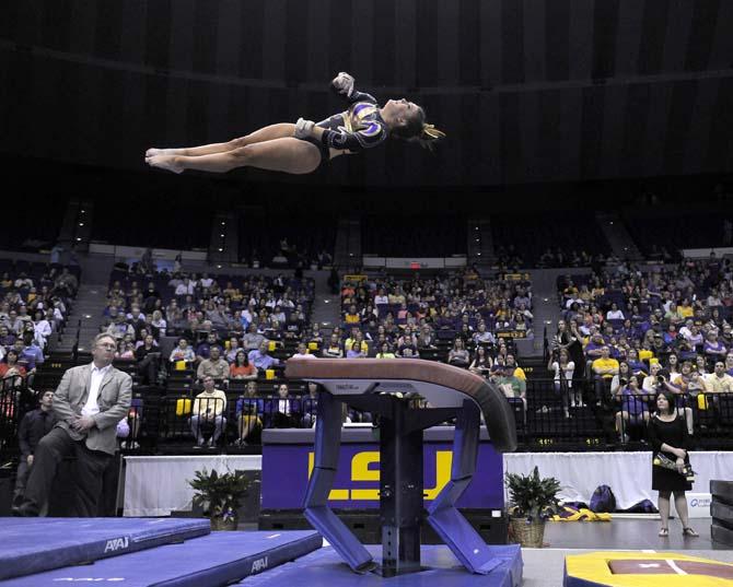 LSU freshman Sydney Ewing flys on vault Friday, March 14, 2014 during the Lady Tigers' 197.800-195.000 victory against Kentucky in the PMAC