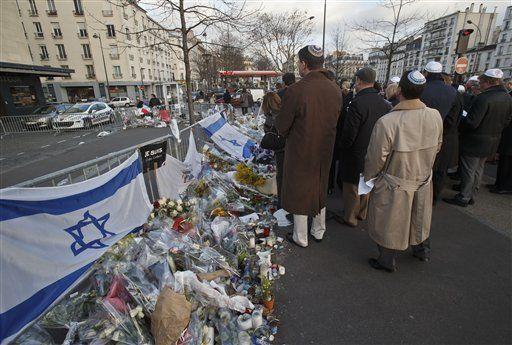 Member of the Jewish Federations of North America gather outside kosher grocery store as they visit the site in Paris, Sunday Feb. 8, 2015, where four people where killed in a terror attack. Member of the Jewish Federation of North America traveled to Paris to show support with victims of the terror attack a month ago. (AP Photo/Michel Euler)