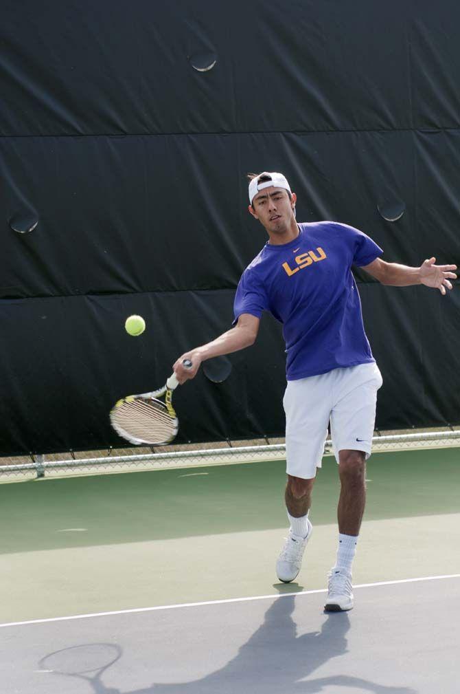 LSU junior tennis player Boris Arias serves the ball during practice Thursday, Feb. 5, 2015.