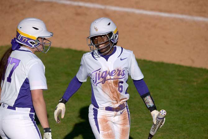 LSU senior outfield A.J. Andrews (6) celebrates with junior catcher Kellsi Kloss (77) after running home on Saturday, Feb. 7, 2015 during the Tiger' 10-0 victory against Tennessee State in Tiger Park.