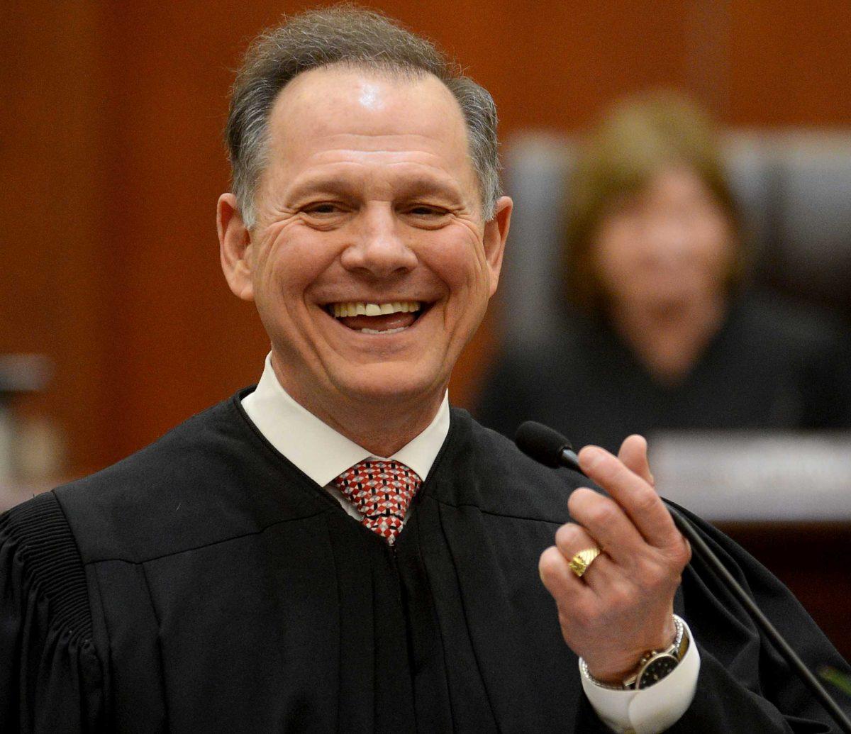 FILE -In this Friday, Jan. 11, 2013 file photo, Alabama Chief Justice Roy Moore talks to the crowd after being sworn into office, at the Heflin-Torbert Judicial Building in Montgomery, Ala. Gays and lesbians could get marriage licenses in more than half of Alabama's counties Friday after a federal judge told a county judge that he must not defy her ruling striking down the state's same-sex marriage ban. Moore has remained defiant, demanding that the state's probate judges keep refusing to issue licenses to same-sex couples until the final word from the nation's highest court. (AP Photo/AL.com, Julie Bennett, File)