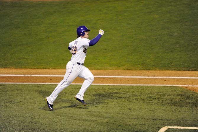 LSU senior catcher Kade Scivicque (22) scores a home run on Friday, Feb. 13, 2015 during the Tigers' 4-1 victory against Kansas in Alex Box Stadium.