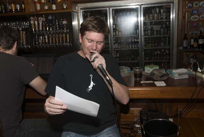 Mile Hatfield "Let's Get Quizzical" owner reads questions during trivia night on Monday, March. 09, 2015, at the Chimes in Highland Rd.