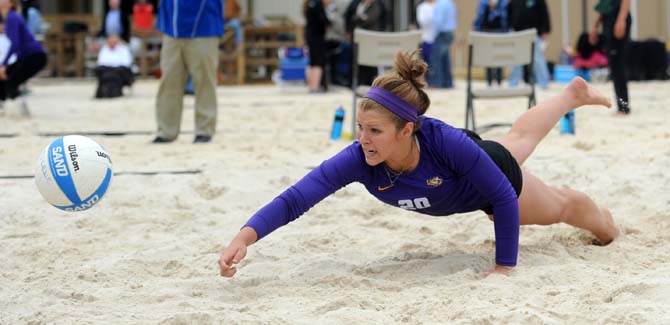 Then-freshman sand volleyball player Emma Hiller (20) dives for the ball Wednesday, March 26, 2014, during the Tigers' 3-2 loss against Tulane at Coconut Beach Sand Volleyball Complex.