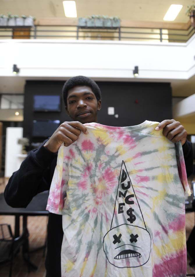 Graphic design freshman Joshua Henderson holds up a creation on March 6, 2015, from his New Orleans-based clothing company FD.