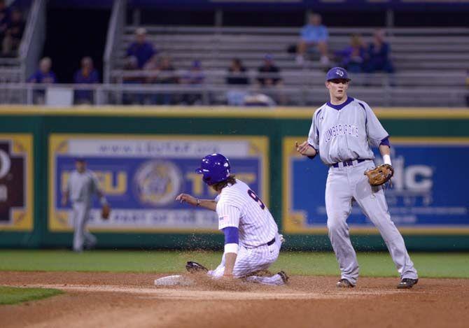 LSU junior outfielder Mark Laird (9) slides into second base Tuesday, Mar. 3, 2015 in game against Stephen F. Austin in the Alex Box Stadium.