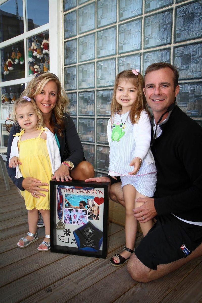 The Bowmans celebrate in August 2011 at Crawfish Aquatics after attending a swim meet dedicated to Bella (second from right).