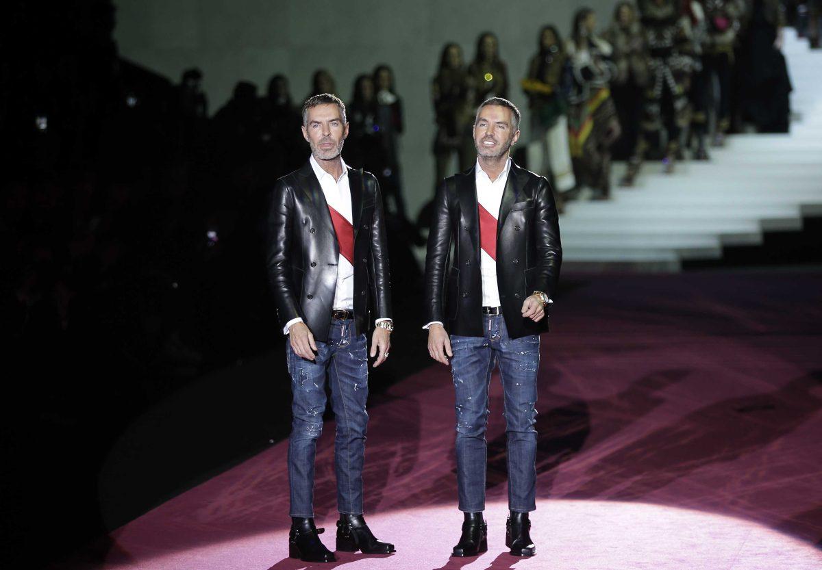 Canadian fashion designers Dean Caten, right, and Dan Caten acknowledge the applause of the audience after presenting their DSquared2 women's Fall-Winter 2015-2016 collection, part of the Milan Fashion Week, unveiled in Milan, Italy, Monday, March 2, 2015. (AP Photo/Antonio Calanni)