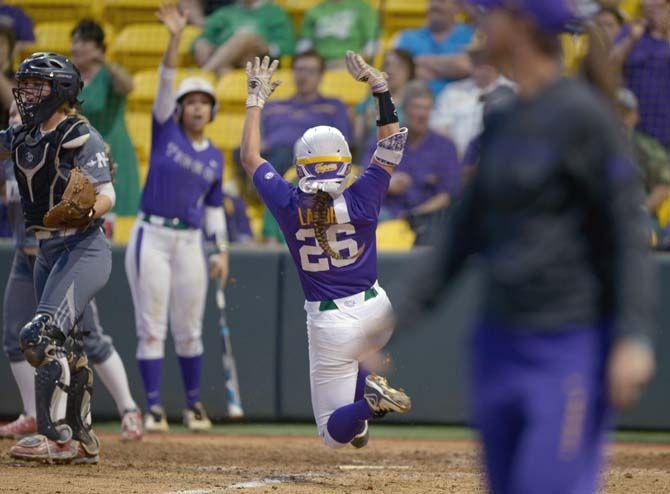 LSU sophomore outfielder Bailey Landry (26) slides towards the home plate on Tuesday, March 17, 2015 during the Tigers' 6-1 win against Nicholls in Tiger Park.