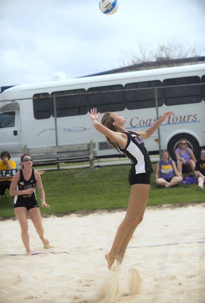 LSU senior Helen Boyle (13) jumps to make a kill during the Tigers' 4-1 defeat against Florida International on Saturday, March 21, 2015 at Mango's Beach Volleyball Club.