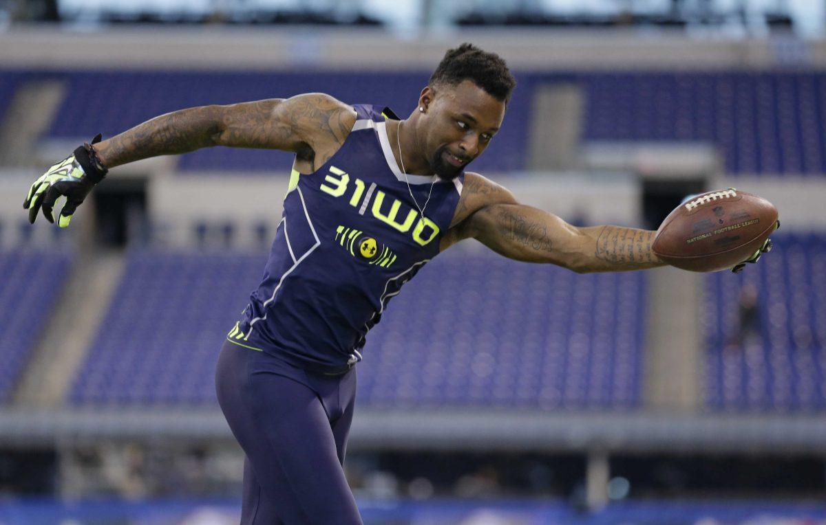 Louisiana State wide receiver Jarvis Landry makes a one-handed catch during a drill at the NFL football scouting combine in Indianapolis, Sunday, Feb. 23, 2014. (AP Photo/Michael Conroy)