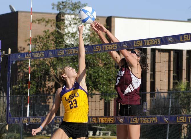 LSU junior Helen Boyle (23) tries to hit around ULM freshman Hadley Swartz (5) on Tuesday, March 18, 2014, during the Tigers' 2-3 loss to the Warhawks at Mango's Outdoor Volleyball.