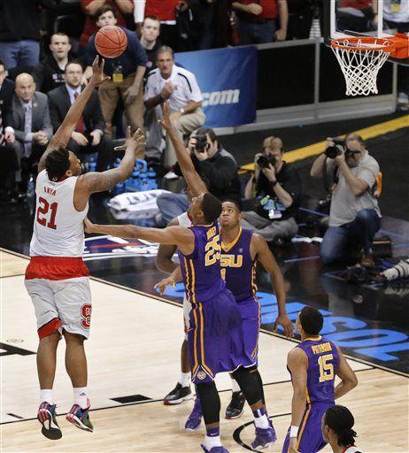 North Carolina State's Beejay Anya (21) shoots the game-winning basket over LSU's Jordan Mickey (25) in an NCAA tournament second round college basketball game Thursday, March 19, 2015, in Pittsburgh. N.C. State won 66-65. (AP Photo/Gene J. Puskar)