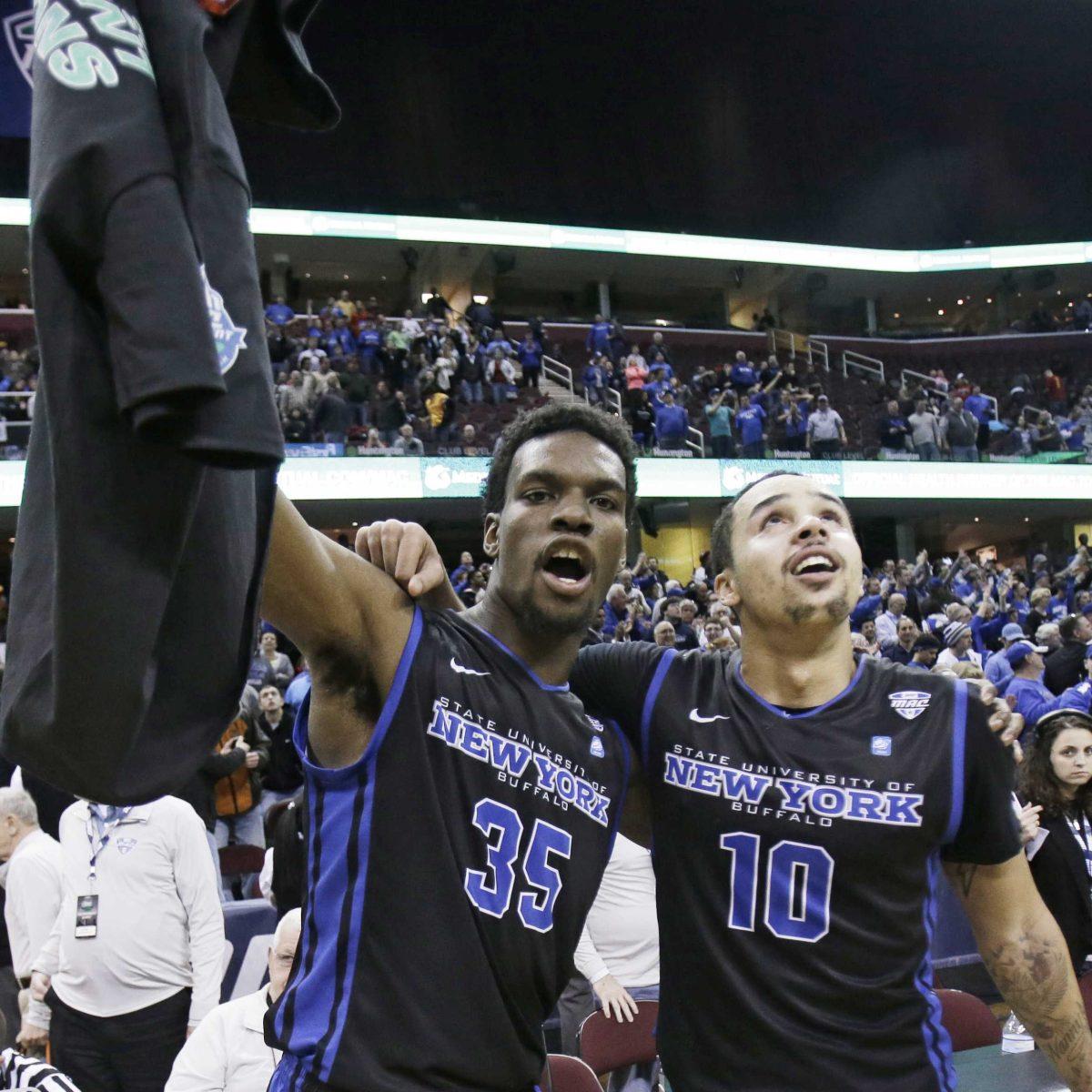 Buffalo's Xavier Ford (35) and Jarryn Skeete (10) celebrate after Buffalo defeated Central Michigan 89-84 in an NCAA college basketball game in the championship of the Mid-American Conference tournament Saturday, March 14, 2015, in Cleveland. (AP Photo/Tony Dejak)