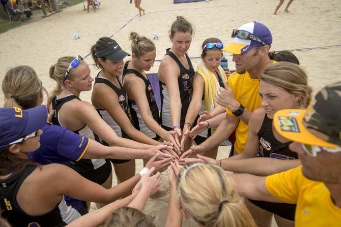 LSU sand volleyball team huddle during the Tigers' 5-0 victory against Spring Hill on Saturday, March 21, 2015 at Mango's Beach Volleyball Club.