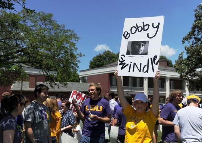 A protestor holds up a sign at the March the Capitol protest where protestors marched towards the Louisiana State Capitol building Thursday, Apr. 30, 2015 in protest of higher education budget cuts.