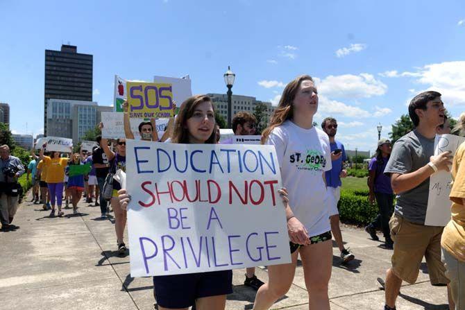 Protestors march towards the Louisiana State Capitol building Thursday, Apr. 30, 2015 in protest of higher education budget cuts.