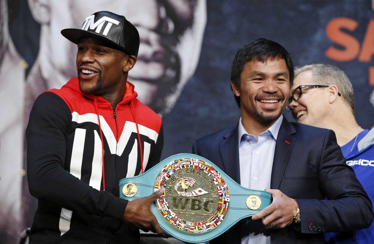 Boxers Floyd Mayweather Jr., left, and Manny Pacquiao pose with a WBC belt during a press conference Wednesday, April 29, 2015, in Las Vegas. Mayweather will face Pacquiao in a welterweight title fight in Las Vegas on May 2. (AP Photo/John Locher)