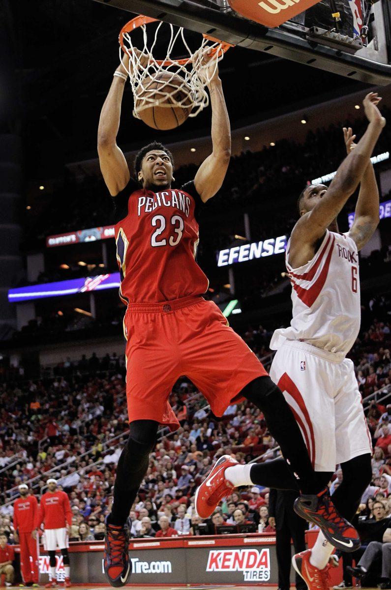 New Orleans Pelicans forward Anthony Davis (23) dunks as Houston Rockets forward Terrence Jones (6) is late defending during the second half of an NBA basketball game Sunday, April 12, 2015, in Houston. Houston won 121-114. (AP Photo/Bob Levey)