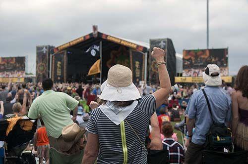 Festival goers hold their fists in the air duing a performance at Congo Square Friday, Apr. 24, 2015 at New Orleans Jazz &amp; Heritage Festival.