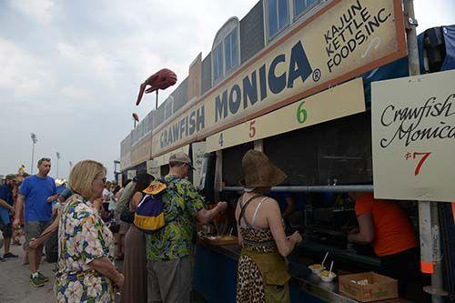 Festival goers lineup in front of the food vendors Satuday, Apr. 25, 201 including Kajun Kettle Foods, Inc. and their famous "Crawfish Monica" at New Orleans Jazz &amp; Heritage Festival.