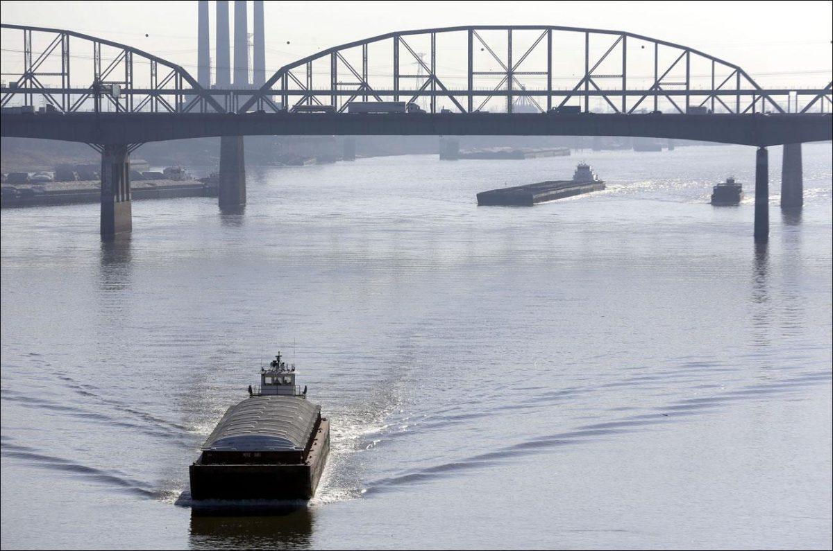 Barges power their way up the Mississippi River on Friday in St. Louis. (AP Photo/Jeff Roberson)