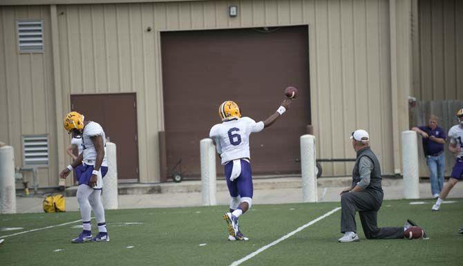 LSU sophomore quarterback Brandon Harris (6) passes the ball while junior quarterback Anthony Jennings (10) looks down during practice on Thursday, March 19, 2015 in Charls McClendon Practice Facility