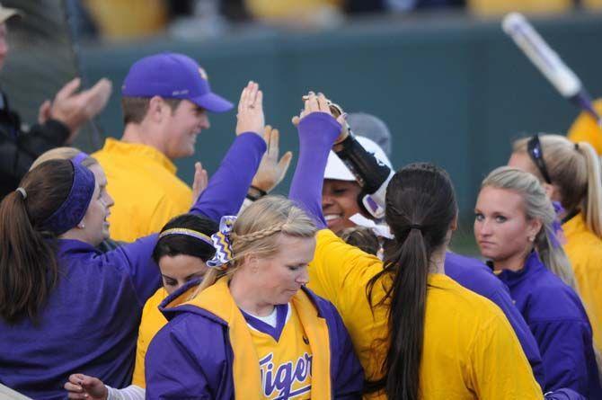 Bianka Bell recieving praise after making a home run and getting Bailey Landry home, scoring two points on Friday, Feb. 6, 2015, during the LSU vs. Memphis game at Tiger Park.