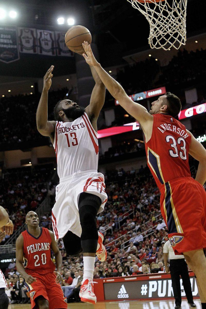 Houston Rockets guard James Harden (13) drives to the basket over New Orleans Pelicans forward Ryan Anderson (33) during the first half of an NBA basketball game Sunday, April 12, 2015, in Houston. (AP Photo/Bob Levey)