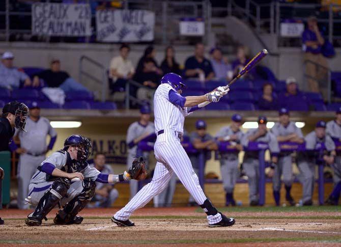 LSU junior outfielder Mark Laird (9) hits the ball Tuesday, Mar. 3, 2015 in the Alex Box Stadium.