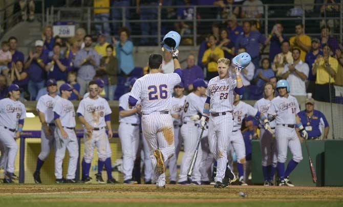 LSU junior catcher Chris Chinea (26) is congratulated at home plate Tuesday, April 21, 2015 after hitting a home-run during the Tigers' 6-0 victory against Tulane at Alex Box Stadium.