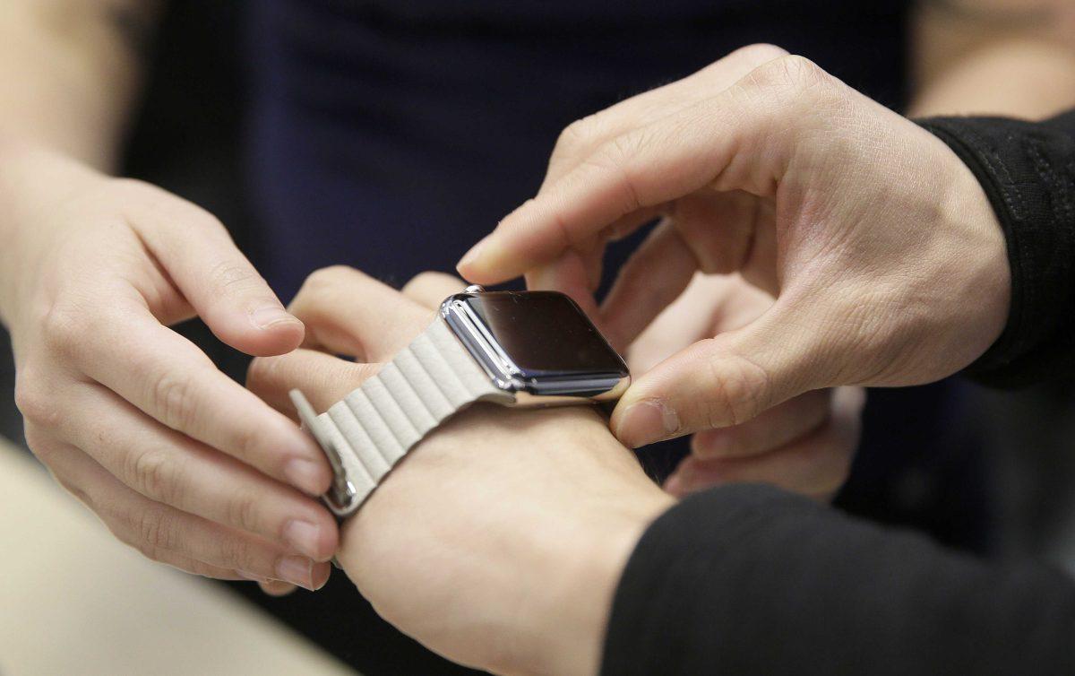 A customer tries on Apple's new watch at a store in San Francisco. The Apple Watch's heart rate monitor might not work if there is a tattoo on the wearer's wrist.