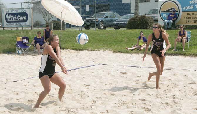 LSU senior Laura Whalen (3) hits the ball as junior Emily Ehrle (2) watches during the Tigers' 4-1 defeat against Florida International on Saturday, March 21, 2015 at Mango's Beach Volleyball Club.