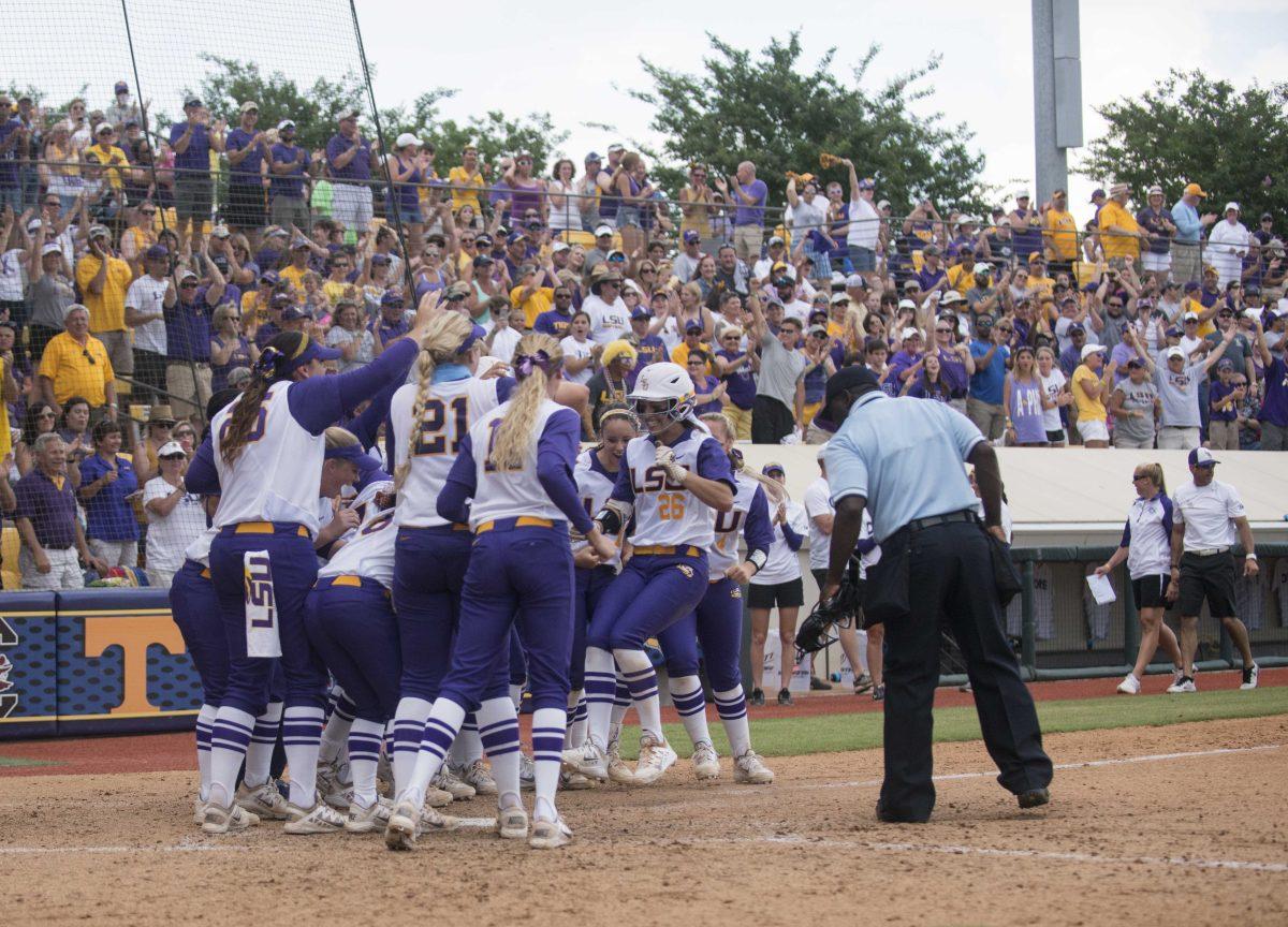 LSU sophomore outfielder Bailey Landry (26) is greeted by her teammates after scoring a homerun during the Tiger's 8-0 first victory against Arizona on Saturday, May 23, 2015 in Tiger Park.