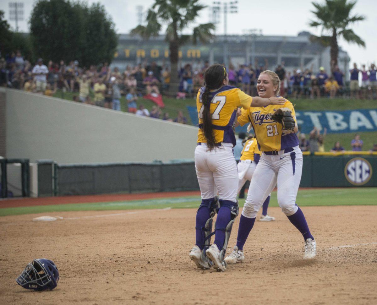 LSU junior catcher Kellsi Kloss (77) jumps to hug freshman pitcher Carley Hoover (21) after the Tiger's 10-5 final victory against Arizona on Sunday, May 24, 2015 in Tiger Park.