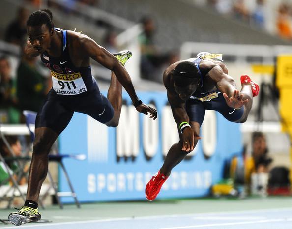 Aaron Earnest (left) crosses the finish line for a silver medal in the 200-meter dash at the IAAF World Junior Championships as Tyreek Hill (right) stumbles in at third.