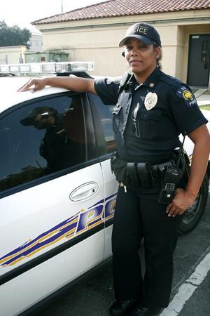 LSUPD officer Carrie Heckard-Richardson stands next to one of the department's cars this past Friday.