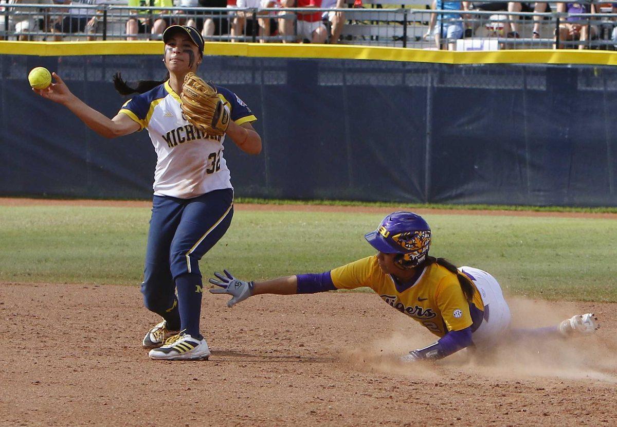 Michigan's Sierra Romero throws to first base after putting outLSU's Savanna Jaquish in the fifth inning during an NCAA Women's College World Series softball game in Oklahoma City, Sunday, May 31, 2015. Michigan won 6-3 and moves on to the championship series. (AP Photo/Alonzo Adams)