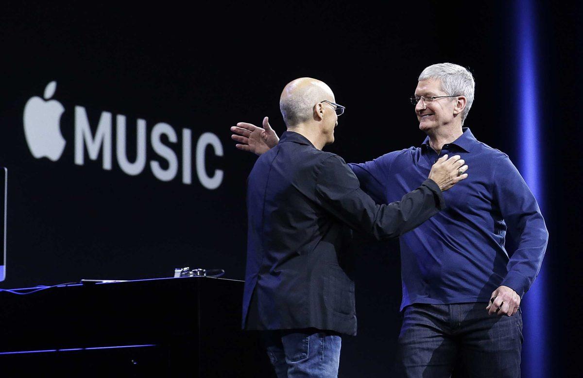 Apple CEO Tim Cook, right, hugs Beats by Dre co-founder and Apple employee Jimmy Iovine at the Apple Worldwide Developers Conference in San Francisco, Monday, June 8, 2015. The maker of iPods and iPhones announced Apple Music, its new, paid streaming-music service to launch this summer. (AP Photo/Jeff Chiu)