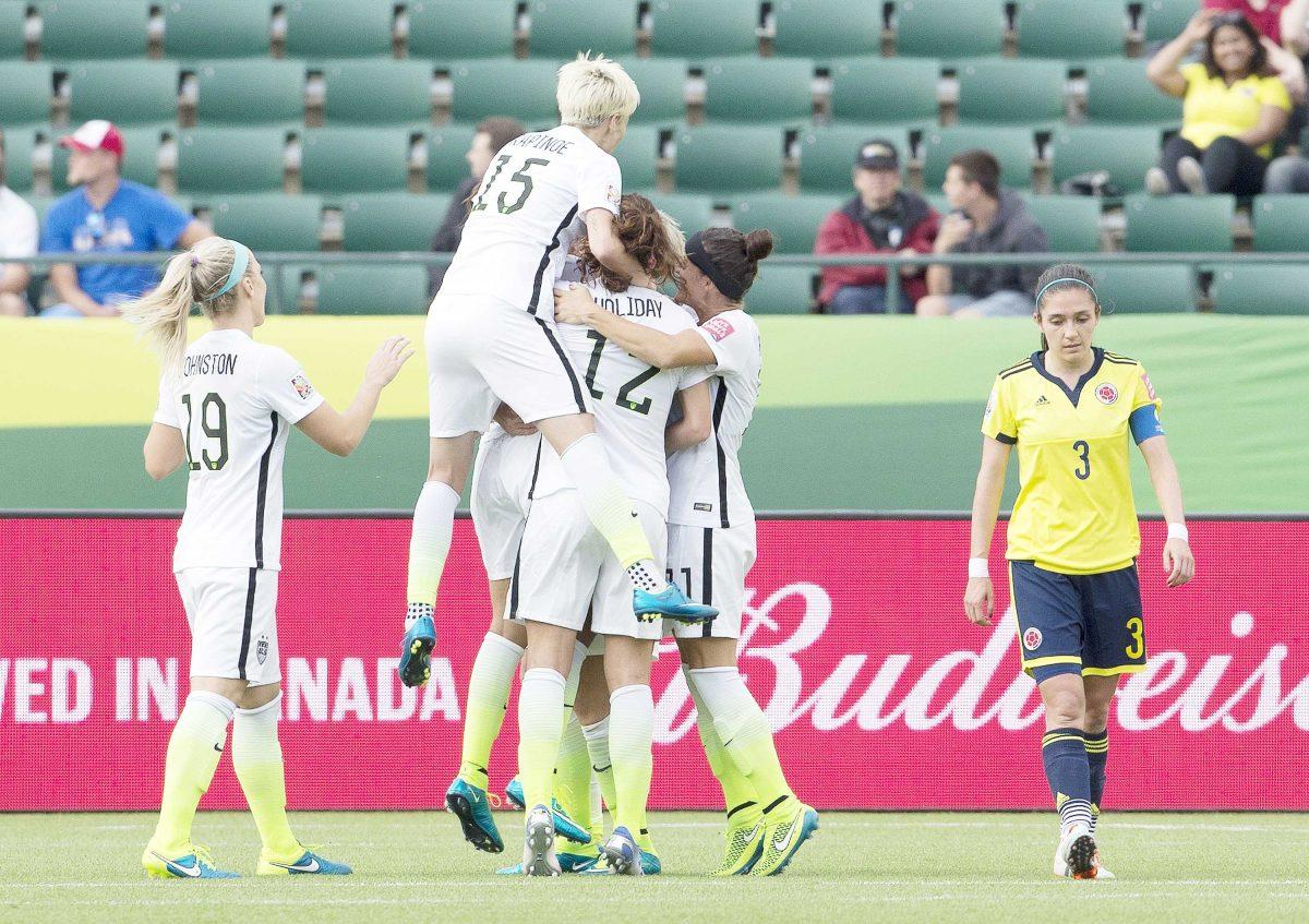 The United States celebrates a goal as Colombia's Natalia Gaitan (3) walks past during the second half of a second round soccer game in the FIFA Women's World Cup round in Edmonton, Alberta, Canada, on Monday June 22, 2015. The U.S. won 2-0. (Jason Franson/The Canadian Press via AP) MANDATORY CREDIT