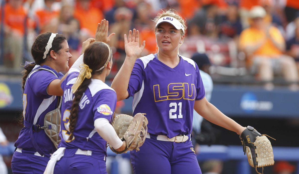 LSU's Carley Hoover (21) is congratulated by teammates Kellsi Kloss, left, and Sandra Simmons, center, after defeating Auburn in a game in the NCAA Women's College World Series softball tournament in Oklahoma City, Thursday, May 28, 2015. LSU won 6-1. (AP Photo/Sue Ogrocki)