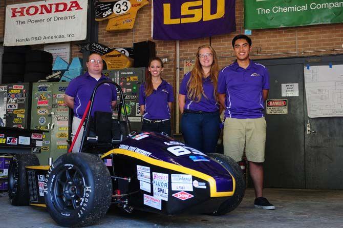 LSU mechanical engineering junior Eric Rohli, finance sophomore Emily Latham, computer science freshman Leslie Morgan and mechanical engineering junior Van Le stand behind the TigerRacing team's formula-style racecar, "Chelsea" on Tuesday, July 14, 2015 in the Engineering Annex Building.