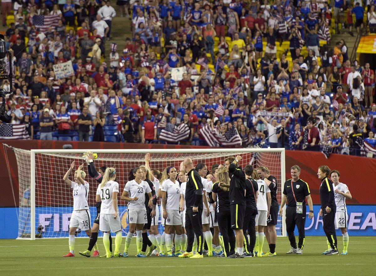 The U.S. team salutes fans after defeating Germany 2-0 in a semifinal in the Women's World Cup soccer tournament, Tuesday, June 30, 2015, in Montreal, Canada. (Ryan Remiorz/The Canadian Press via AP)