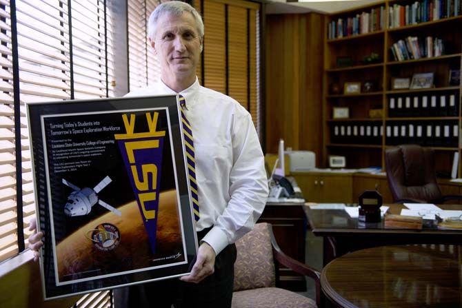 Dean of the LSU College of Engineering Rick Koubek holds a commemorative gift from NASA which celebrates a partnership with the space organization on Wednesday, July 1, 2015, in Patrick F. Taylor Hall.