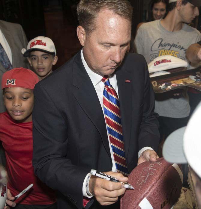 Ole Miss head football coach, High Freeze, autographs a fan’s football during SEC Media Days on Thursday, July 16, 2015 in Hoover, Alabama.