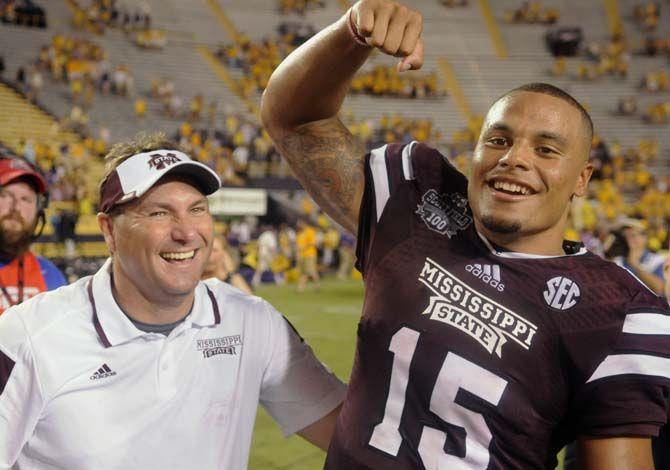 Mississippi State Football head coach Dan Mullen and junior quaterback Dak Prescott (15) rejoice after their team defeated the Tigers 34-29 in Tiger Stadium Saturday, September 20, 2014.